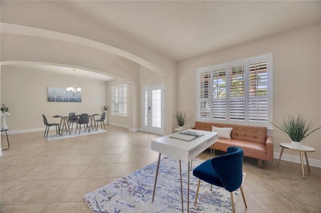 1229 Hillandale Reserve Dr, Tampa, FL 33613 - living room with a chandelier, arched walkways, and light tile patterned flooring