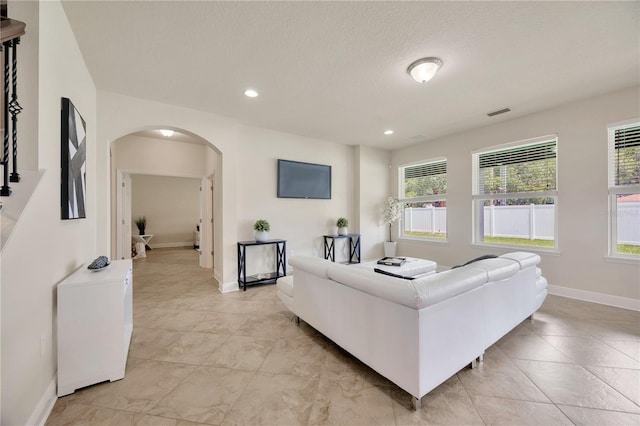 1229 Hillandale Reserve Dr, Tampa, FL 33613 - living area with arched walkways, recessed lighting, and light tile patterned floors