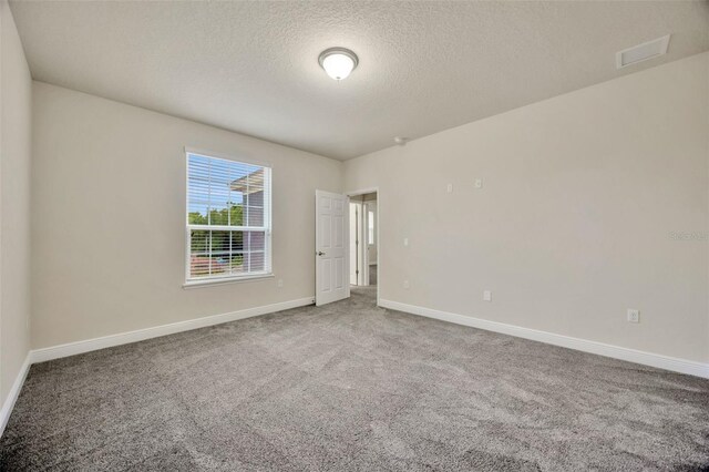1229 Hillandale Reserve Dr, Tampa, FL 33613 - carpeted empty room featuring a textured ceiling and baseboards