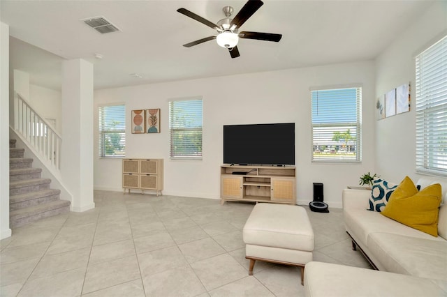 3228 Bryant Park Dr, New Port Richey, FL 34655 - tiled living room with healthy amount of natural light, ceiling fan, stairway, and baseboards