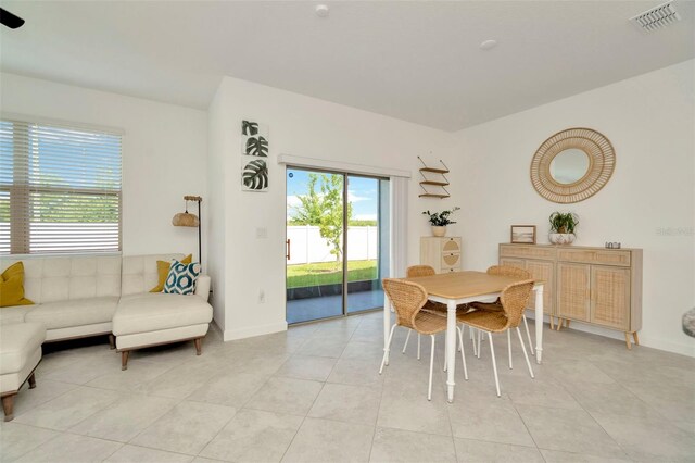 3228 Bryant Park Dr, New Port Richey, FL 34655 - dining space featuring healthy amount of natural light, light tile patterned floors, and baseboards
