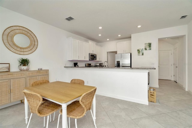 3228 Bryant Park Dr, New Port Richey, FL 34655 - dining room featuring recessed lighting, light tile patterned floors, and baseboards