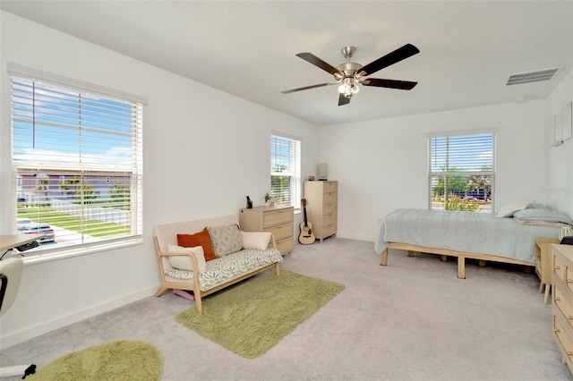3228 Bryant Park Dr, New Port Richey, FL 34655 - bedroom with multiple windows, baseboards, light colored carpet, and a ceiling fan