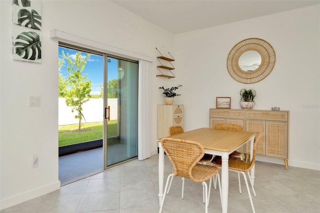 3228 Bryant Park Dr, New Port Richey, FL 34655 - dining room with light tile patterned flooring and baseboards