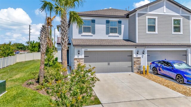 3228 Bryant Park Dr, New Port Richey, FL 34655 - townhome / multi-family property with a garage, stone siding, concrete driveway, and a shingled roof