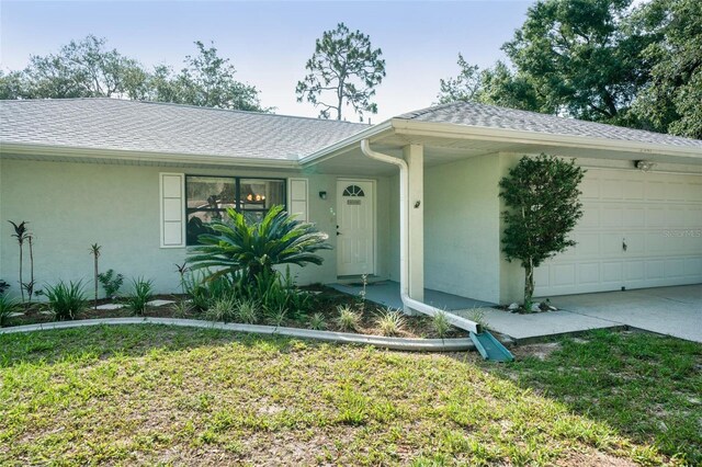 3341 S Jean Pt, Inverness, FL 34450 - single story home with stucco siding, a garage, roof with shingles, and a front yard