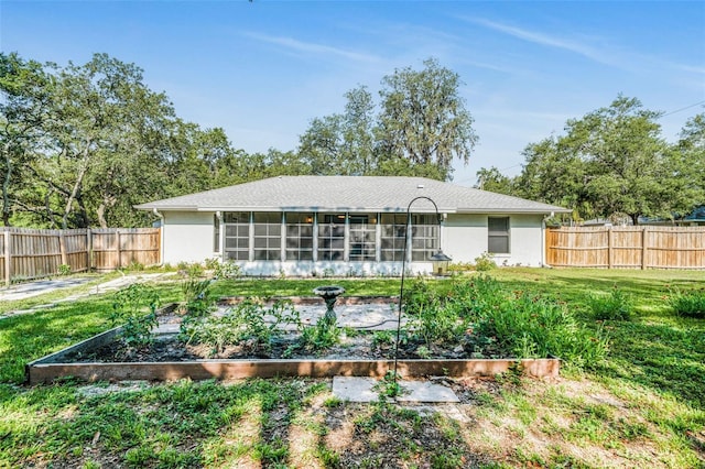 3341 S Jean Pt, Inverness, FL 34450 - back of property with a garden, a sunroom, and stucco siding