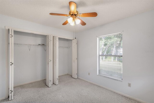 3341 S Jean Pt, Inverness, FL 34450 - unfurnished bedroom with multiple closets, carpet floors, ceiling fan, and baseboards