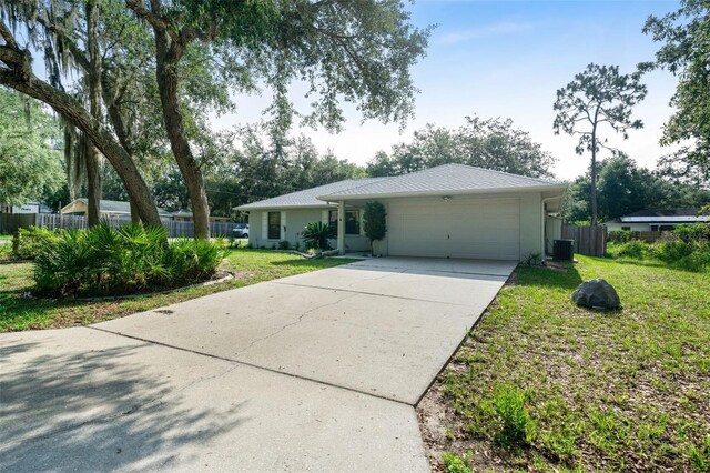 3341 S Jean Pt, Inverness, FL 34450 - ranch-style house with a garage, concrete driveway, stucco siding, and central AC
