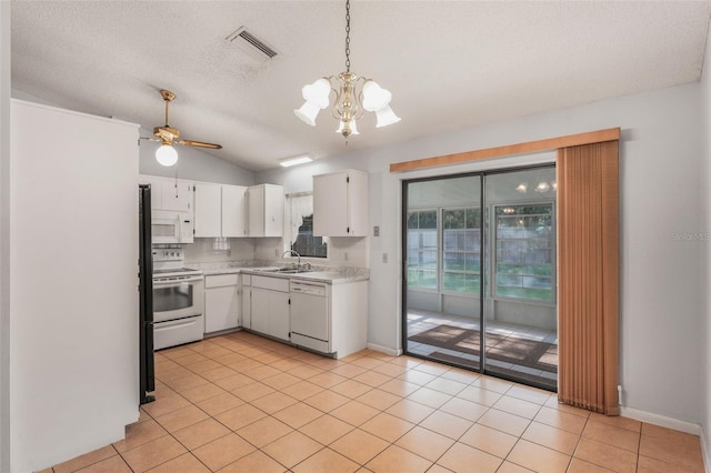 3341 S Jean Pt, Inverness, FL 34450 - kitchen featuring white appliances, light countertops, a chandelier, white cabinetry, and vaulted ceiling