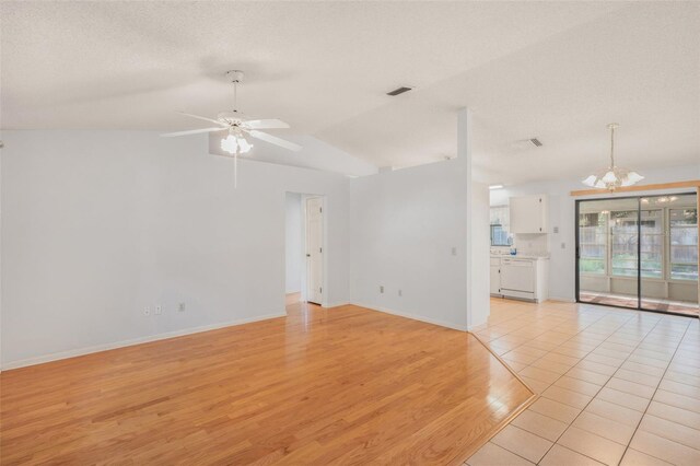 3341 S Jean Pt, Inverness, FL 34450 - unfurnished room featuring a chandelier, light wood-style flooring, ceiling fan, baseboards, and a textured ceiling