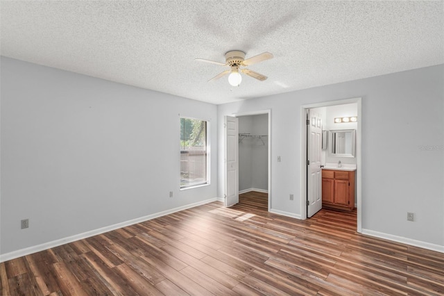3341 S Jean Pt, Inverness, FL 34450 - unfurnished bedroom with wood finished floors, a textured ceiling, a closet, baseboards, and ceiling fan