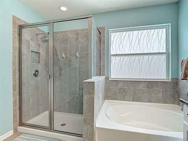 1022 Montgomery Bell Rd, Wesley Chapel, FL 33543 - bathroom featuring a garden tub, a shower stall, and recessed lighting