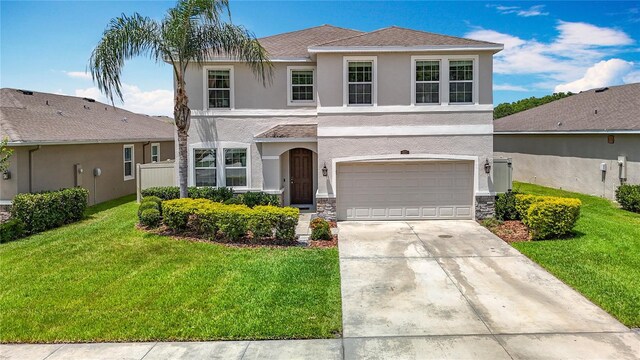 1022 Montgomery Bell Rd, Wesley Chapel, FL 33543 - traditional-style home with stucco siding, an attached garage, concrete driveway, and a front lawn