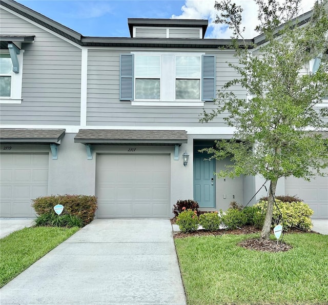 2717 Chestnut Creek Pl, Brandon, FL 33510 - view of property with a garage, stucco siding, roof with shingles, and concrete driveway