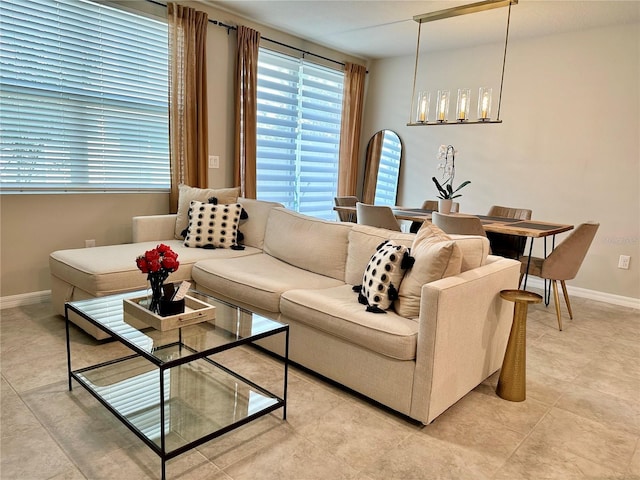 2717 Chestnut Creek Pl, Brandon, FL 33510 - living room featuring a chandelier, baseboards, and light tile patterned floors