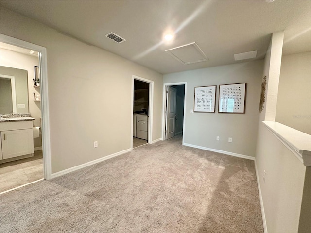 2717 Chestnut Creek Pl, Brandon, FL 33510 - unfurnished bedroom featuring washer and clothes dryer, attic access, a spacious closet, and light colored carpet