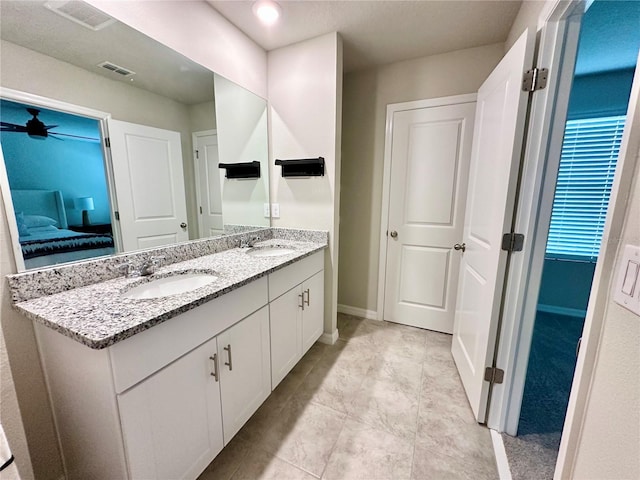 2717 Chestnut Creek Pl, Brandon, FL 33510 - ensuite bathroom with double vanity, baseboards, ceiling fan, and tile patterned flooring