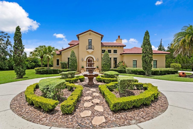 7713 Still Lakes Dr, Odessa, FL 33556 - mediterranean / spanish-style house with a chimney, a tile roof, and stucco siding