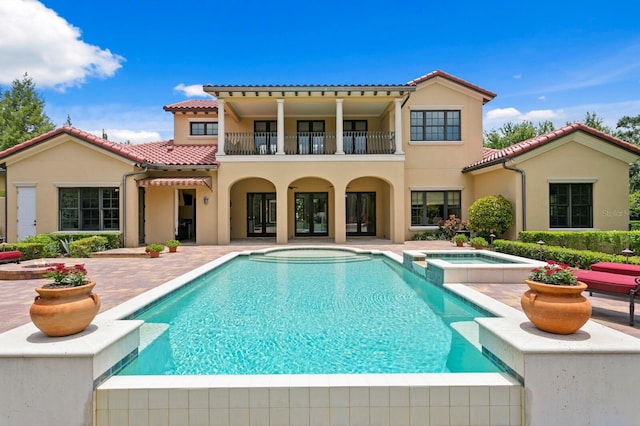 7713 Still Lakes Dr, Odessa, FL 33556 - back of house featuring a balcony, a patio area, a tiled roof, and stucco siding