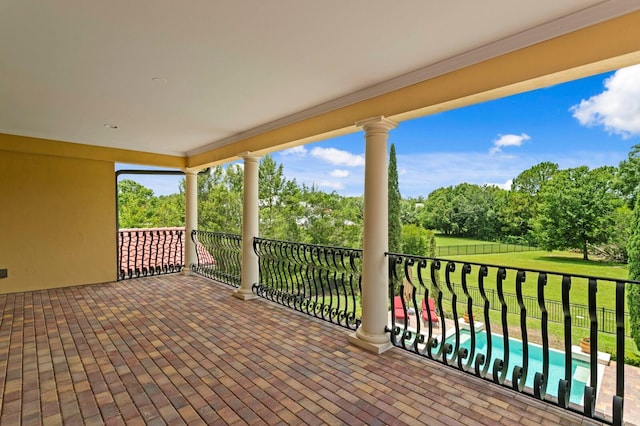 7713 Still Lakes Dr, Odessa, FL 33556 - view of patio / terrace with view of wooded area and a balcony