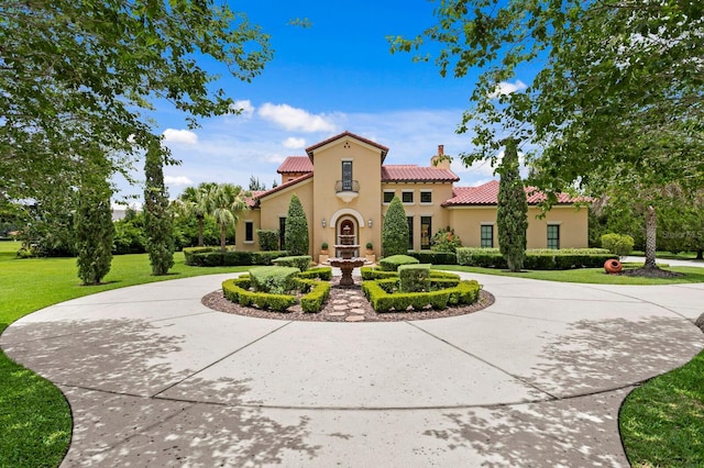 7713 Still Lakes Dr, Odessa, FL 33556 - view of front of home featuring curved driveway, a tiled roof, stucco siding, and a chimney