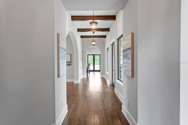 7713 Still Lakes Dr, Odessa, FL 33556 - corridor featuring arched walkways, beam ceiling, dark wood-type flooring, and baseboards