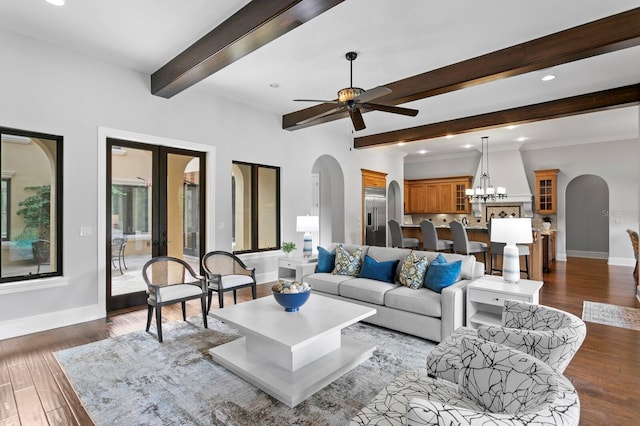 7713 Still Lakes Dr, Odessa, FL 33556 - living room featuring arched walkways, beam ceiling, baseboards, ceiling fan, and wood finished floors