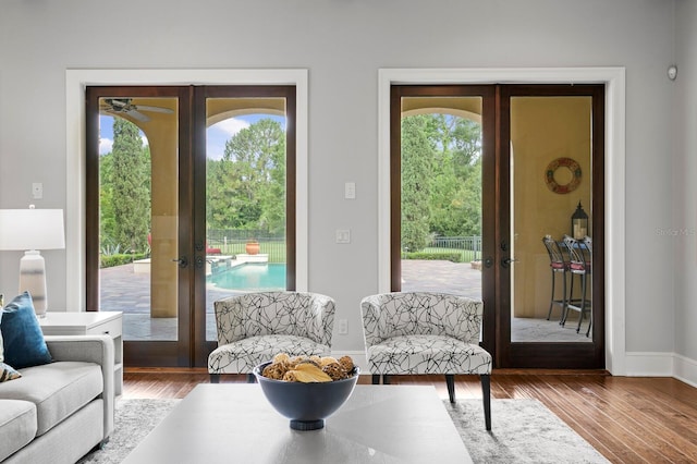 7713 Still Lakes Dr, Odessa, FL 33556 - living area featuring french doors, wood finished floors, a ceiling fan, and healthy amount of natural light