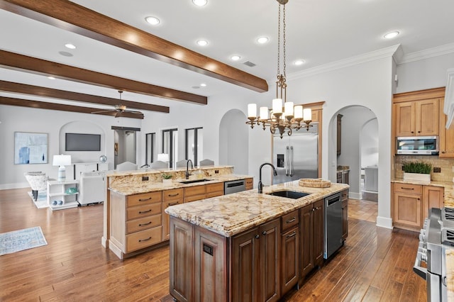 7713 Still Lakes Dr, Odessa, FL 33556 - kitchen featuring arched walkways, an island with sink, a sink, recessed lighting, and beamed ceiling