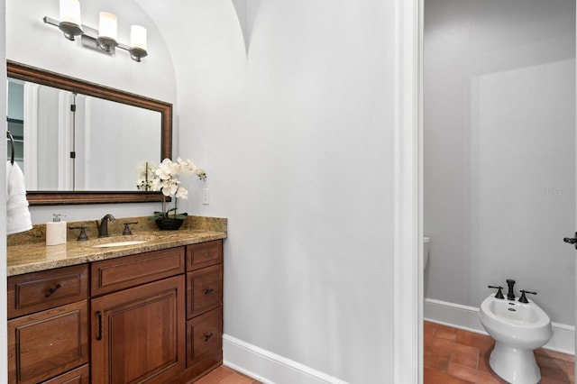 7713 Still Lakes Dr, Odessa, FL 33556 - bathroom featuring a bidet, vanity, and baseboards