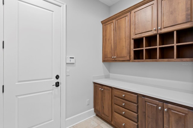 7713 Still Lakes Dr, Odessa, FL 33556 - laundry room with baseboards and light tile patterned flooring