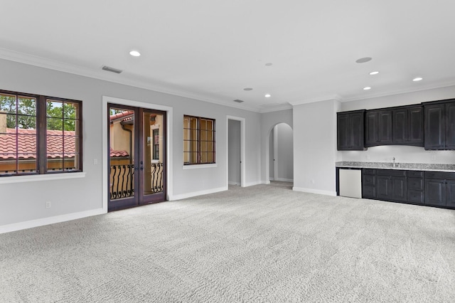 7713 Still Lakes Dr, Odessa, FL 33556 - unfurnished living room with baseboards, arched walkways, recessed lighting, ornamental molding, and light colored carpet