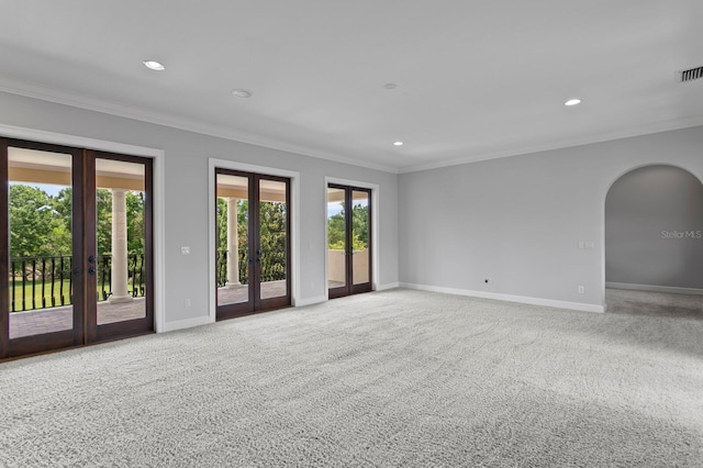 7713 Still Lakes Dr, Odessa, FL 33556 - carpeted empty room featuring french doors, crown molding, baseboards, recessed lighting, and arched walkways