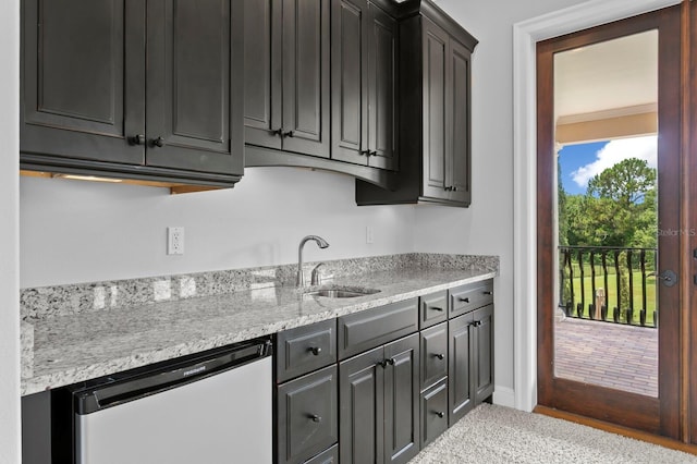 7713 Still Lakes Dr, Odessa, FL 33556 - kitchen with dishwashing machine, a sink, and light stone counters