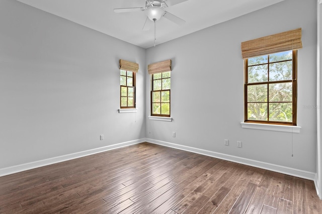 7713 Still Lakes Dr, Odessa, FL 33556 - spare room with a ceiling fan, baseboards, and dark wood finished floors