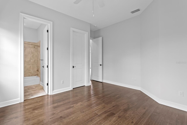 7713 Still Lakes Dr, Odessa, FL 33556 - unfurnished bedroom with wood finished floors, connected bathroom, and baseboards