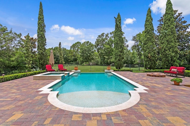 7713 Still Lakes Dr, Odessa, FL 33556 - view of swimming pool with a fire pit, a patio area, a pool with connected hot tub, and view of scattered trees