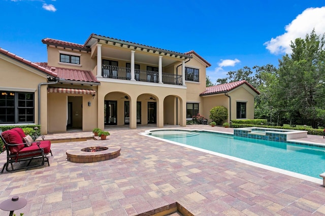 7713 Still Lakes Dr, Odessa, FL 33556 - back of house with a patio, a balcony, a tile roof, and a fire pit