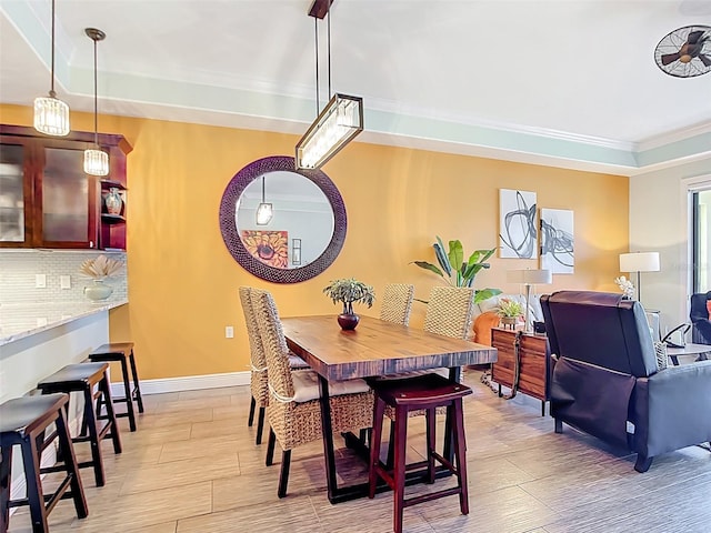 3334 Purple Martin Dr Unit 212, Punta Gorda, FL 33950 - dining space with crown molding, light wood finished floors, and baseboards