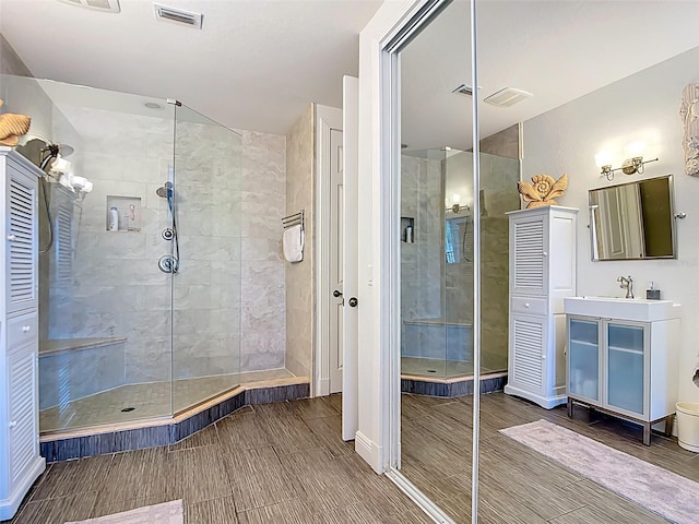 3334 Purple Martin Dr Unit 212, Punta Gorda, FL 33950 - bathroom with tiled shower, vanity, and wood finish floors