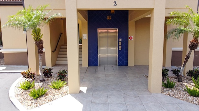 3334 Purple Martin Dr Unit 212, Punta Gorda, FL 33950 - view of exterior entry featuring elevator and stucco siding