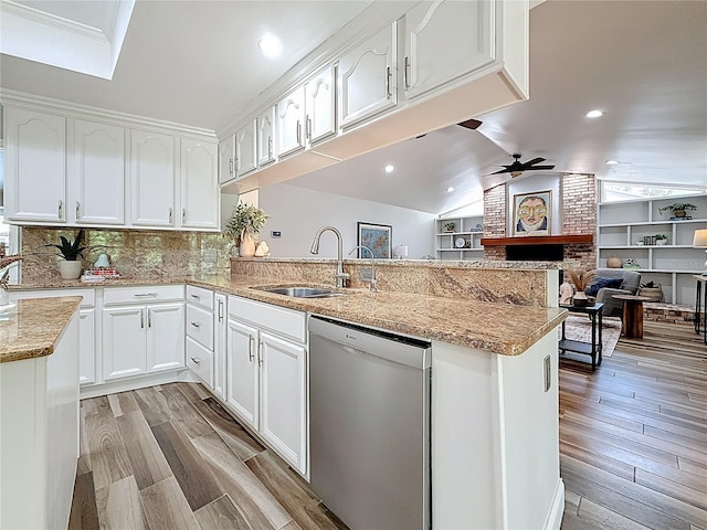 66 Bay Woods Dr, Safety Harbor, FL 34695 - kitchen featuring stainless steel dishwasher, a sink, a peninsula, ceiling fan, and white cabinetry