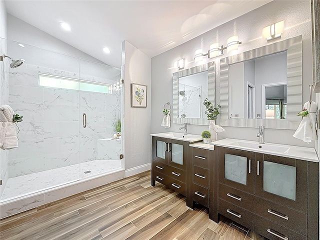 66 Bay Woods Dr, Safety Harbor, FL 34695 - full bath with a marble finish shower, wood finished floors, double vanity, vaulted ceiling, and recessed lighting