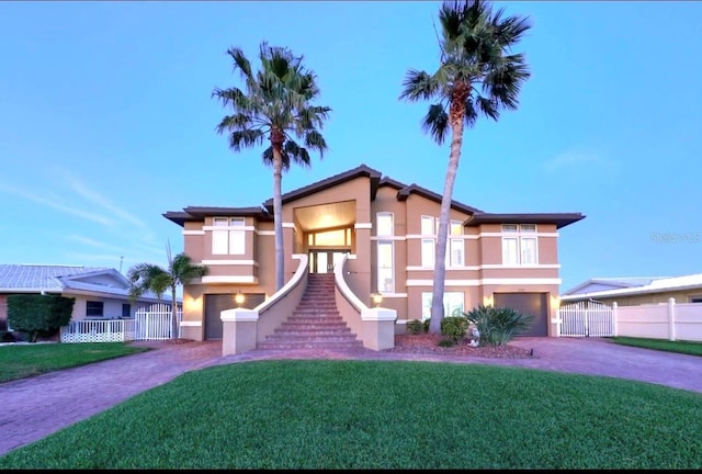 514 Harbor Dr N, Indian Rocks Beach, FL 33785 - view of front of home with an attached garage, stucco siding, and asphalt driveway