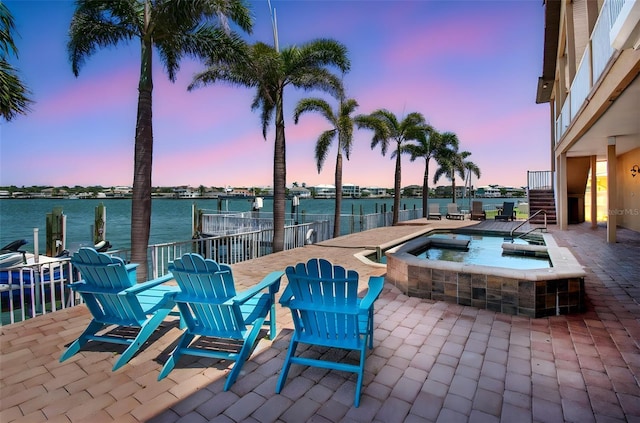 514 Harbor Dr N, Indian Rocks Beach, FL 33785 - view of patio with an in-ground hot tub, a water view, and stairs