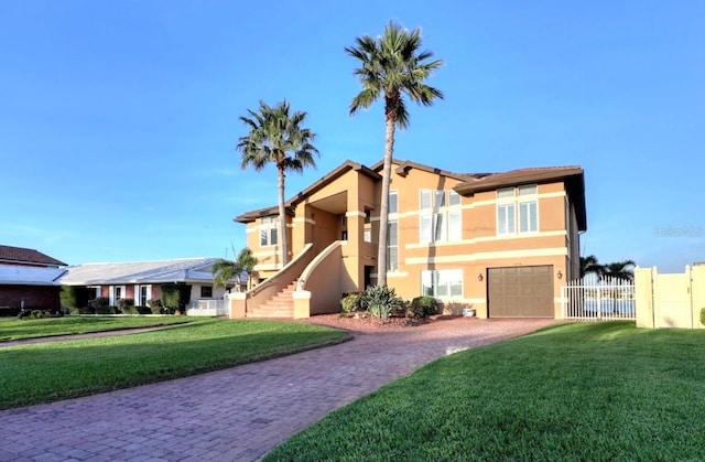 514 Harbor Dr N, Indian Rocks Beach, FL 33785 - view of front of property with decorative driveway, stucco siding, a garage, and stairs