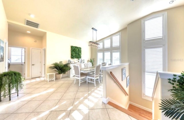 514 Harbor Dr N, Indian Rocks Beach, FL 33785 - dining area with light tile patterned flooring, plenty of natural light, and baseboards