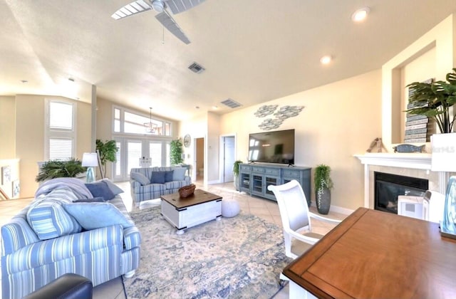 514 Harbor Dr N, Indian Rocks Beach, FL 33785 - tiled living area with vaulted ceiling, a ceiling fan, a glass covered fireplace, and baseboards