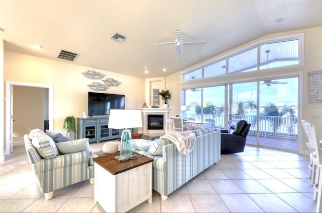 514 Harbor Dr N, Indian Rocks Beach, FL 33785 - living room with ceiling fan, light tile patterned floors, plenty of natural light, and lofted ceiling